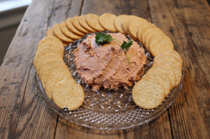 Smoked sockeye salmon spread served on crackers, wild-caught Alaskan seafood.